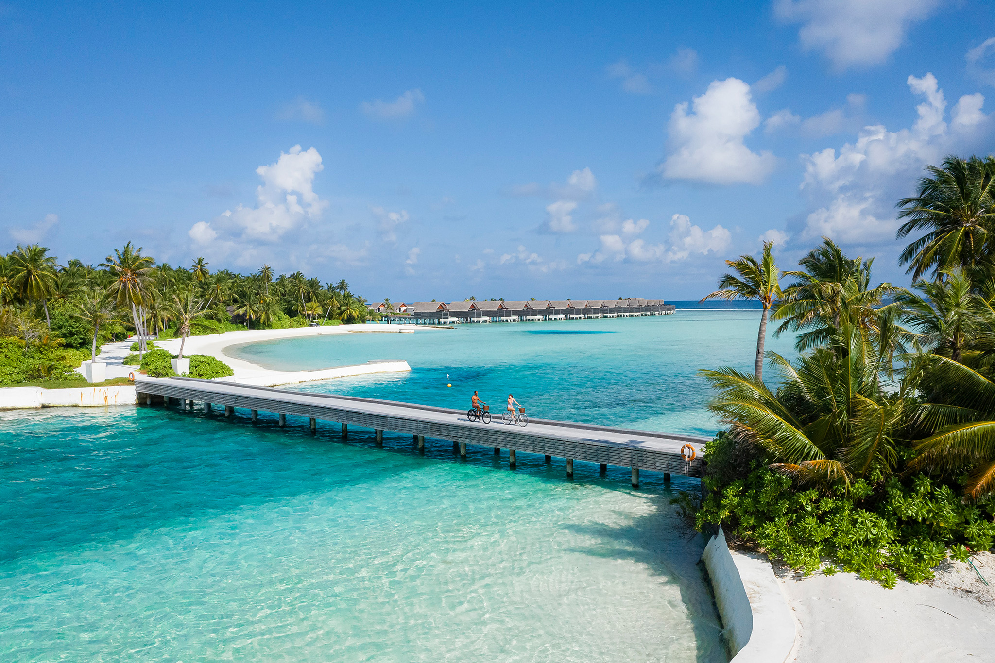 Niyama Private Islands - Bridge with couple cycling